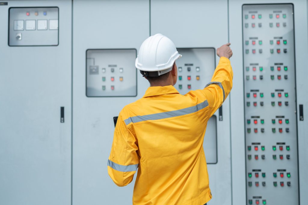 Electrical Engineer Monitoring Systems on Laptop