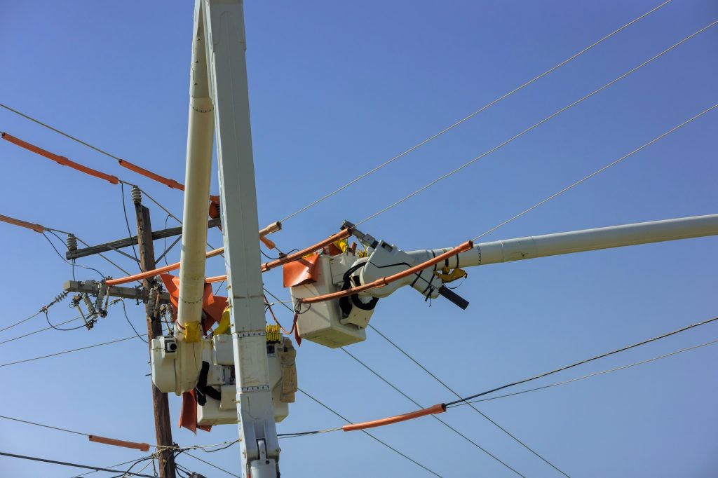 In order to maintains service on power line, lineman uses insulated equipment while climbing a pole