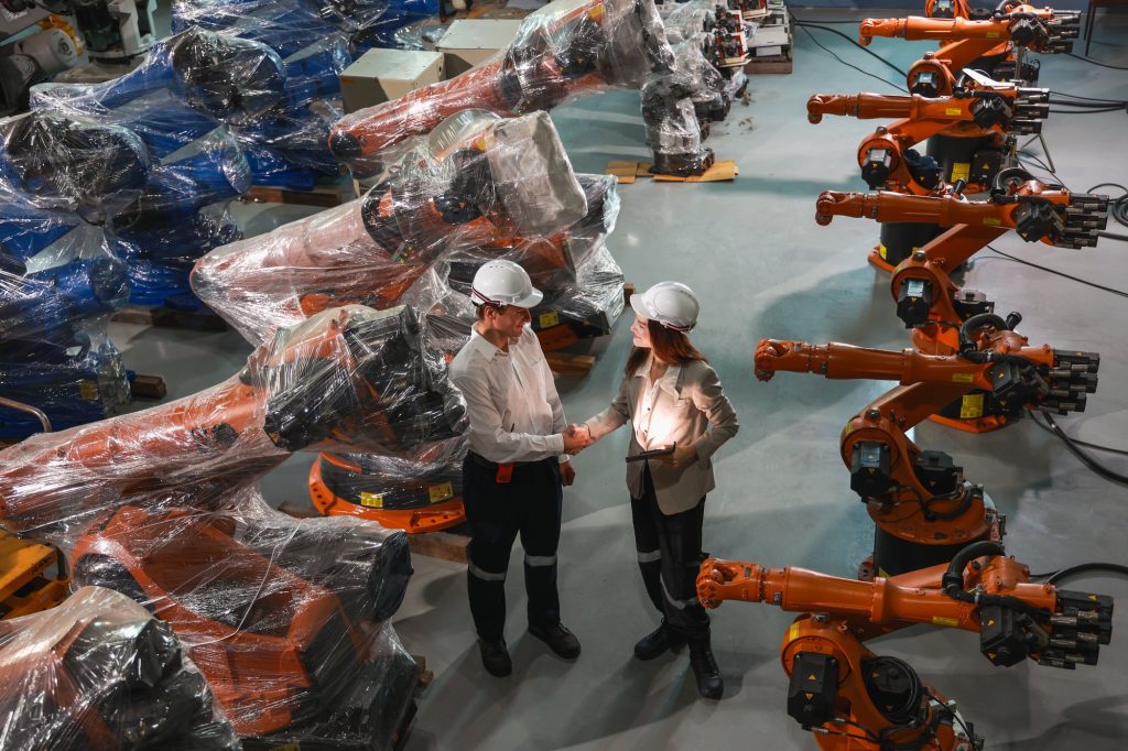 Industrial Robotics Team Completing Factory Equipment Handover