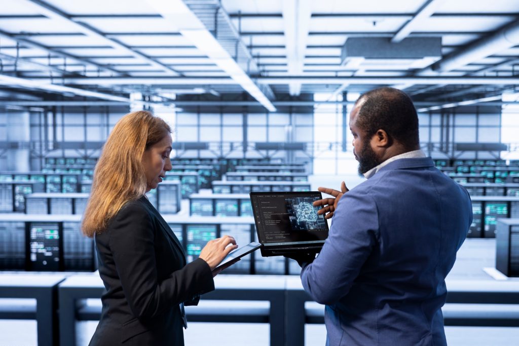 IT staff members in high tech server hub upgrading artificial intelligence