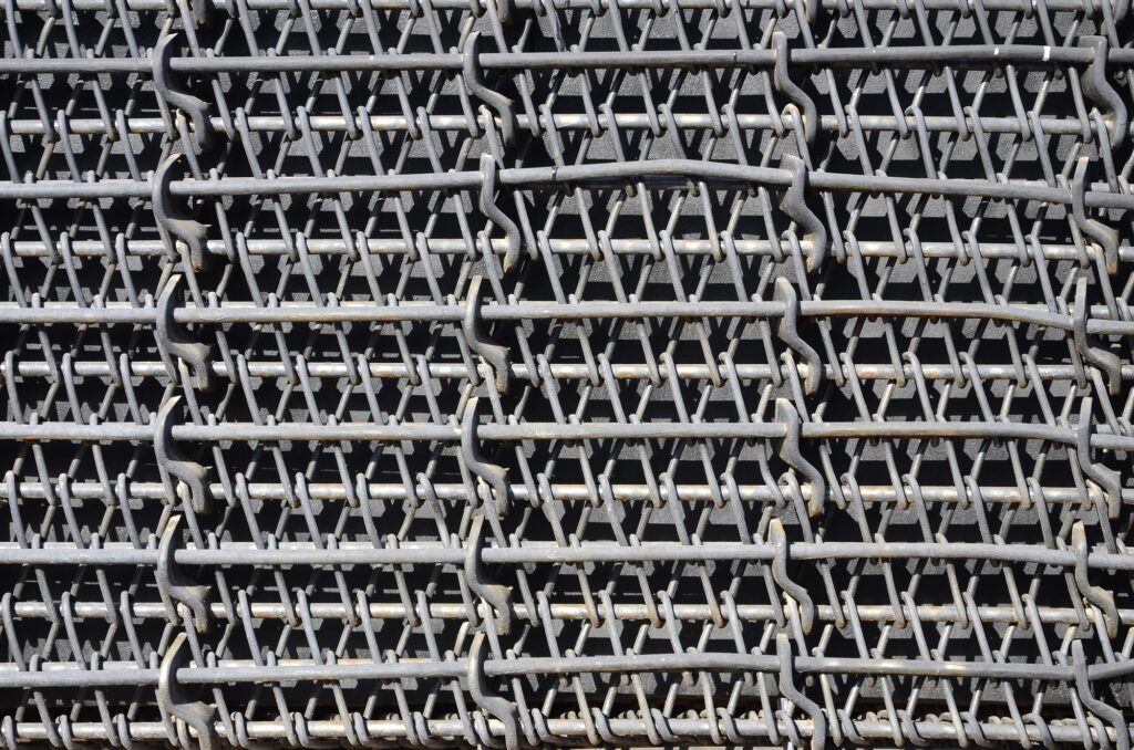 Metal multilayered thick grid of black color. Composite texture