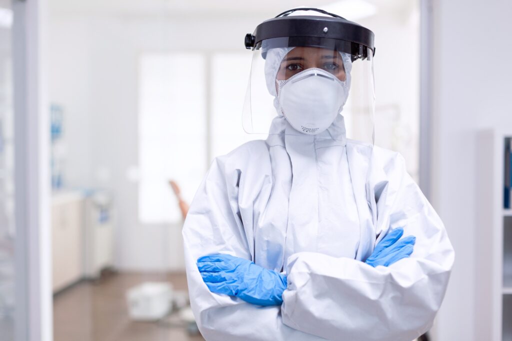 Physician wearing face shield and hazmat suit agasint contamination with coroanvirus