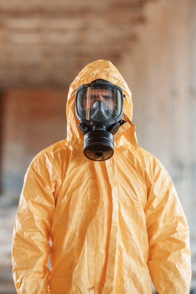 Portrait of man dressed in chemical protection suit that is in the ruins