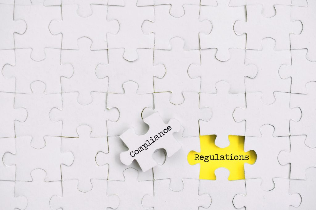 Puzzle pieces Compliance concept - changing procedures to adhere to regulations, yellow