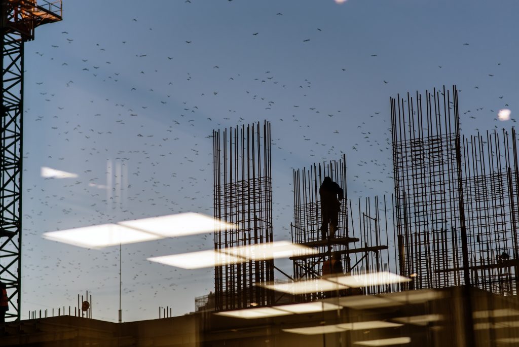 Silhouette construction industry engineer standing orders for worker team to work safety