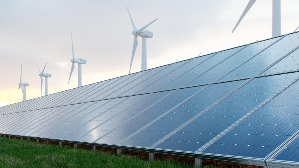 Solar panels and wind turbine on the sky background.