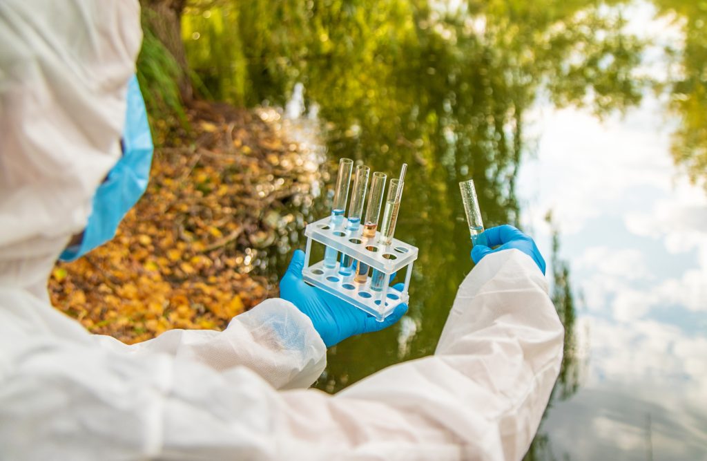 Take water samples for analysis. Selective focus.