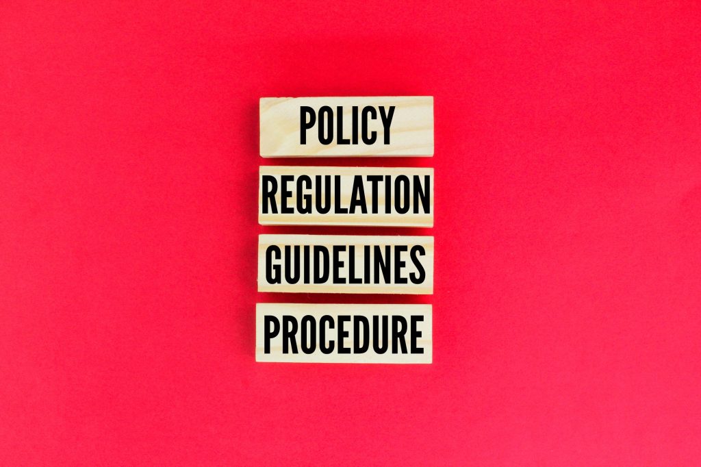 wooden arrangement with the words Policy Regulation Guidelines Procedure.